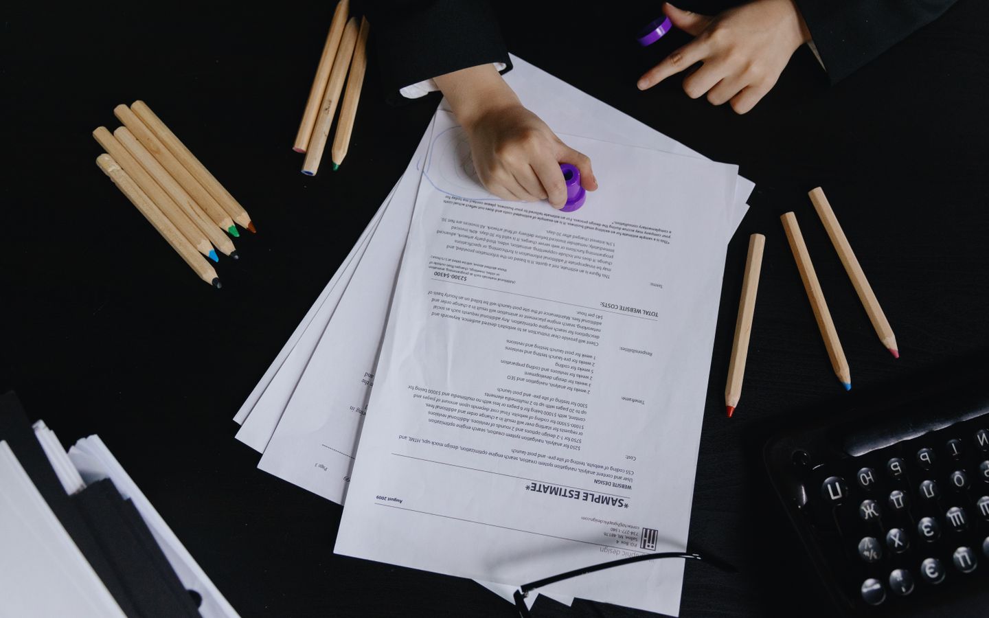 Official paperwork being checked and stamped on a desk
