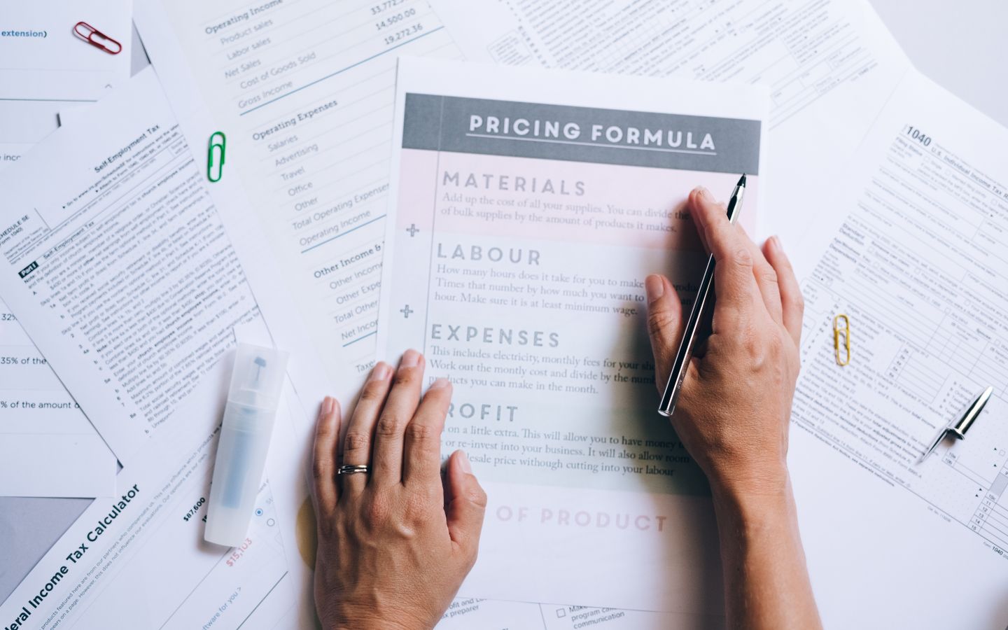 A founder reviewing company costs and paperwork at a desk