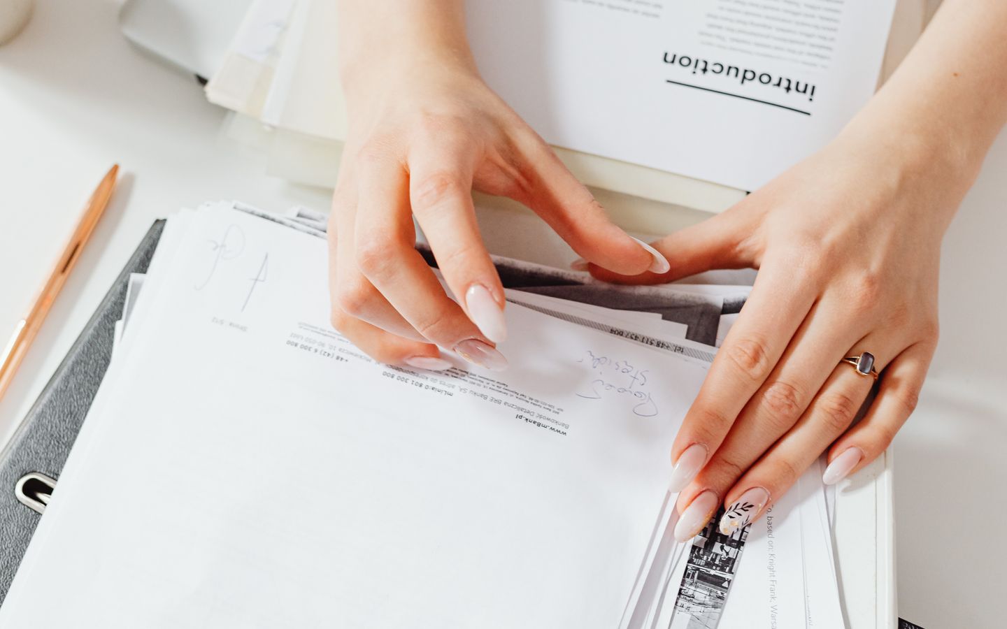 A person checking business documents before submission