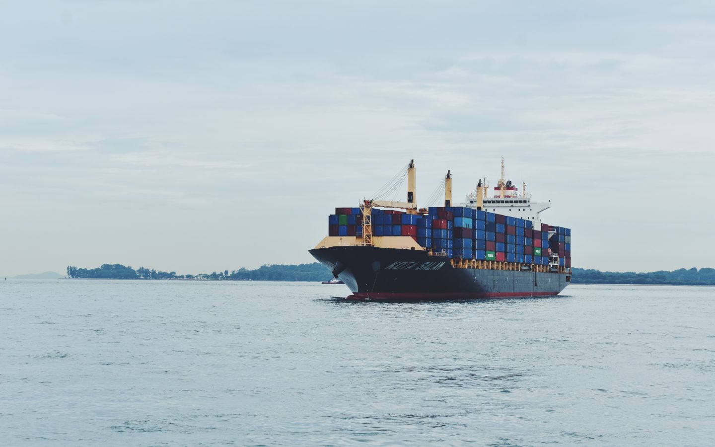 A cargo ship at sea representing an international trading company